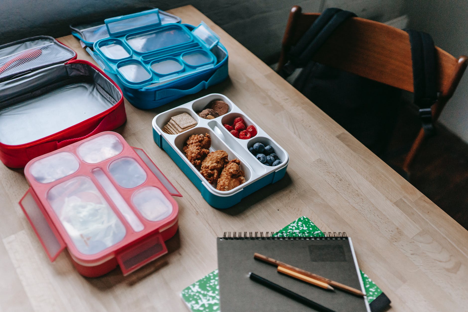 lunch boxes with delicious food in classroom